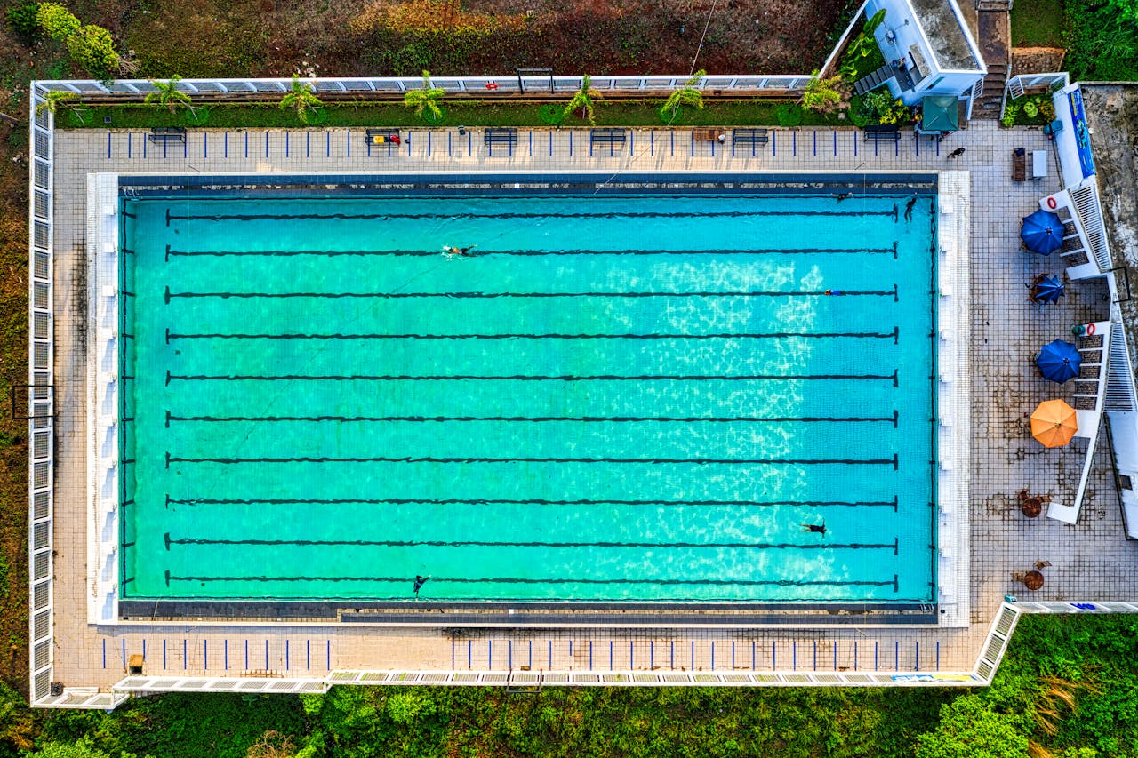 Drone shot of a vibrant swimming pool in Jawa Barat, Indonesia, showing clear turquoise water.